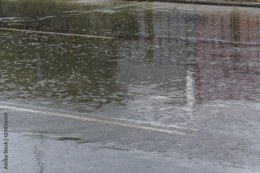 Heavy rain on a road, impact of drops, and reflexion. Heavy rain on a road, impact of drops, and reflexion.