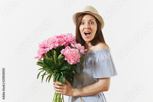 Young happy woman in blue dress, hat holding bouquet of beautiful pink peonies flowers isolated on white background. St. Valentine's Day, International Women's Day holiday concept. Advertising area.