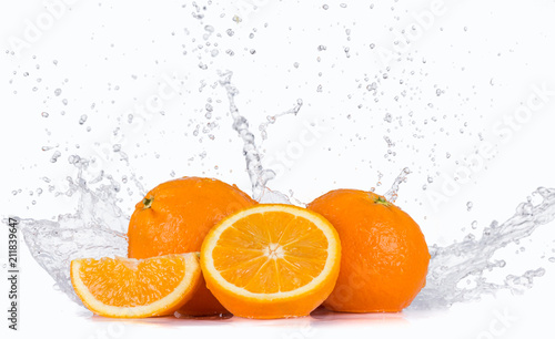 Fresh oranges with water splash over white background.