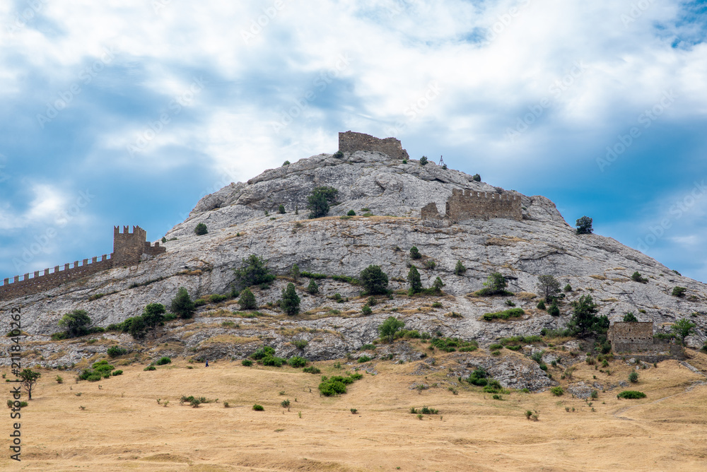 stone mountain with a fortress against the sky stone mountain with a fortress against the sky