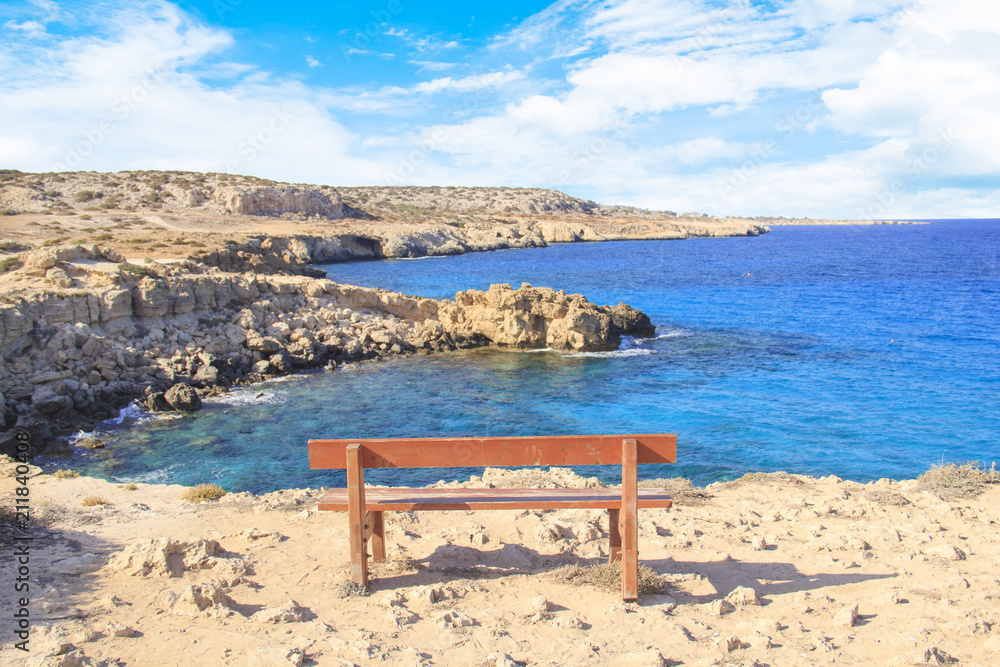 Beautiful view of a lonely bench over the sea