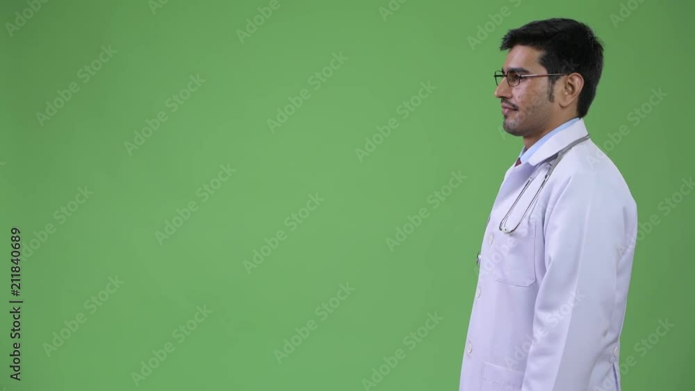 Profile view of young handsome Persian man doctor Profile view of young handsome Persian man doctor