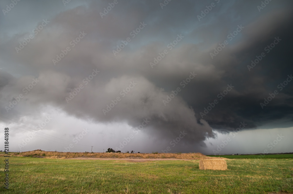 A supercell storm with a low shelf cloud hangs ominously over farmland in Nebraska. A supercell storm with a low shelf cloud hangs ominously over farmland in Nebraska.