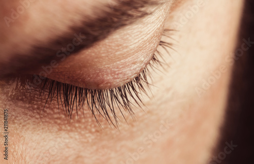 The closed eye of a young man