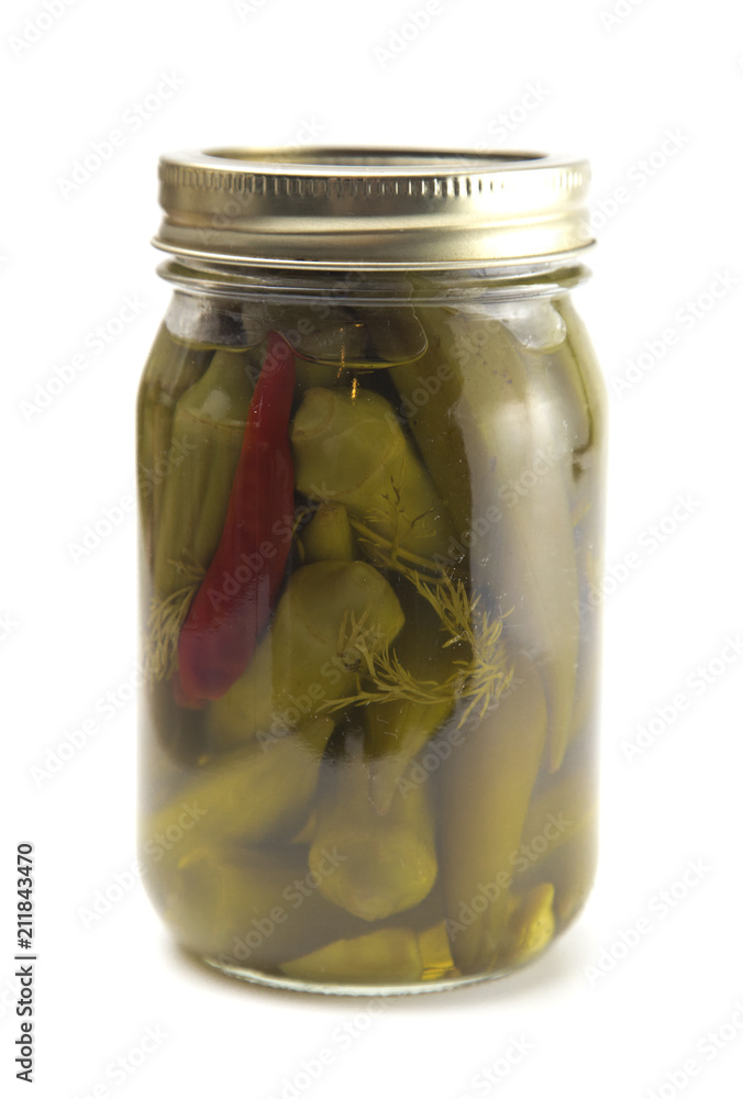Spicy Pickled Okra on a White Background in a Home Canning Jar Spicy Pickled Okra on a White Background in a Home Canning Jar