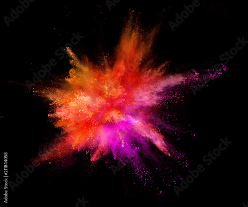 Explosion of coloured powder on black background