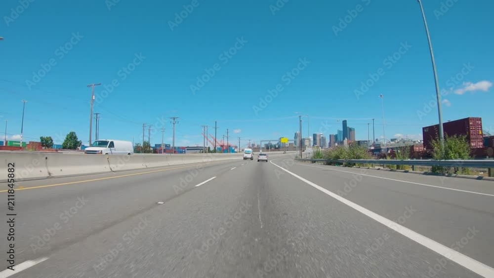 Driving past the train yards into Seattle on a sunny summer day Driving past the train yards into Seattle on a sunny summer day