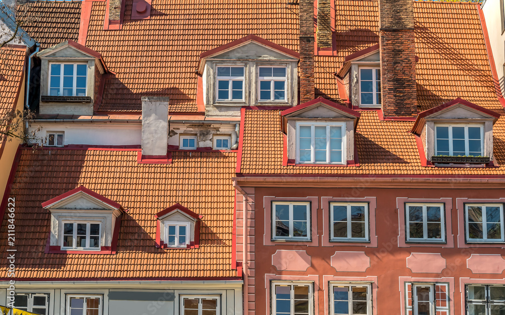 Obraz premium View of old houses walls with windows and roofs in historic center of Riga, Latvia.