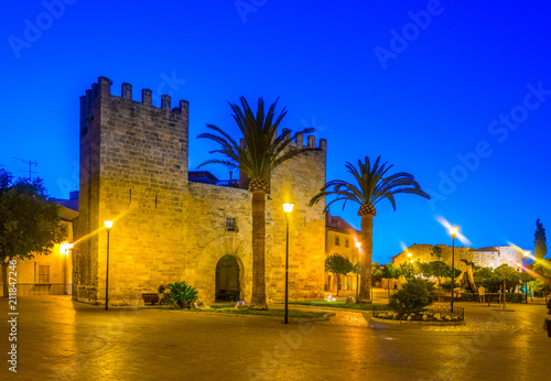 Sunset view of Porta del moll leading to the old town of Alcudia, Mallorca, Spain