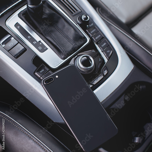 smartphone with dual camera in the interior of a modern car