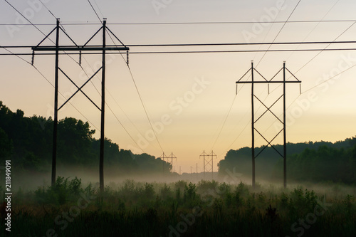 Power lines in the middle of the country, with a nice morning mist