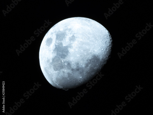 Half Moon  Crescent moon  gibbous moon in the middle of its way on the clear sky.