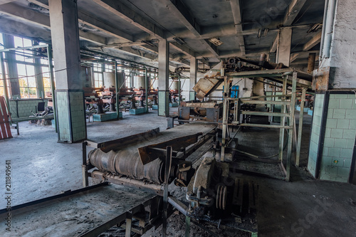 Abandoned tea factory with remnant of rusty equipment. Broken conveyor belt