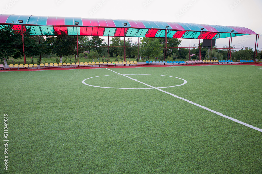 Fototapeta premium Mini Football Goal On An Artificial Grass . Inside of indoor football field . Mini football stadium center