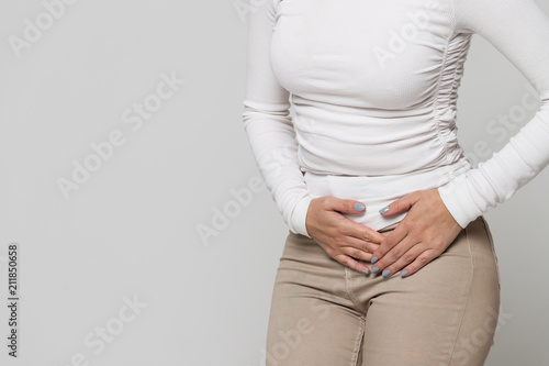 Health issues problems concept.Woman suffering from stomach pain, feeling abdominal pain or cramps.Period menstruation, female health problem, aching belly and gynecology