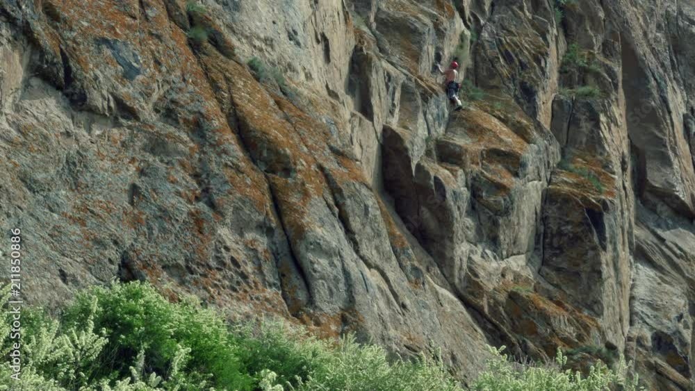 Man climber hiking and climbing the rock Man climber hiking and climbing the rock