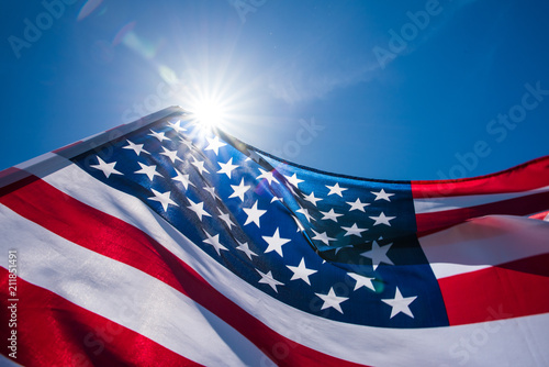 Close up United States of America flag on the blue sky background. USA Independence day, 4 July.