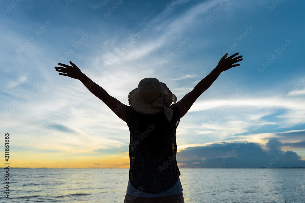 Fototapeta premium People freedom concept. Young woman relaxing in summer sunset sky outdoor.