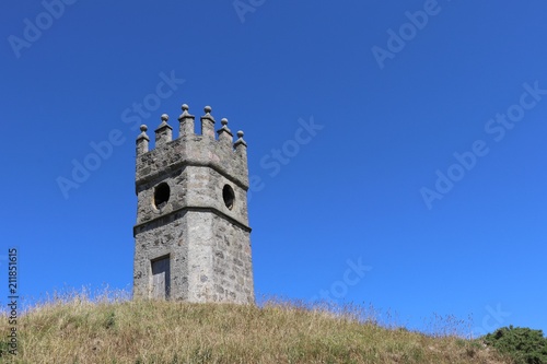Old dovecot, old watchtower on hill against clear blue sky with space for copy