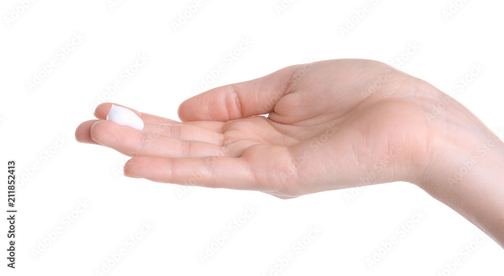 Young woman applying hand cream against on white background Young woman applying hand cream against on white background