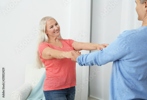 Happy mature couple dancing...