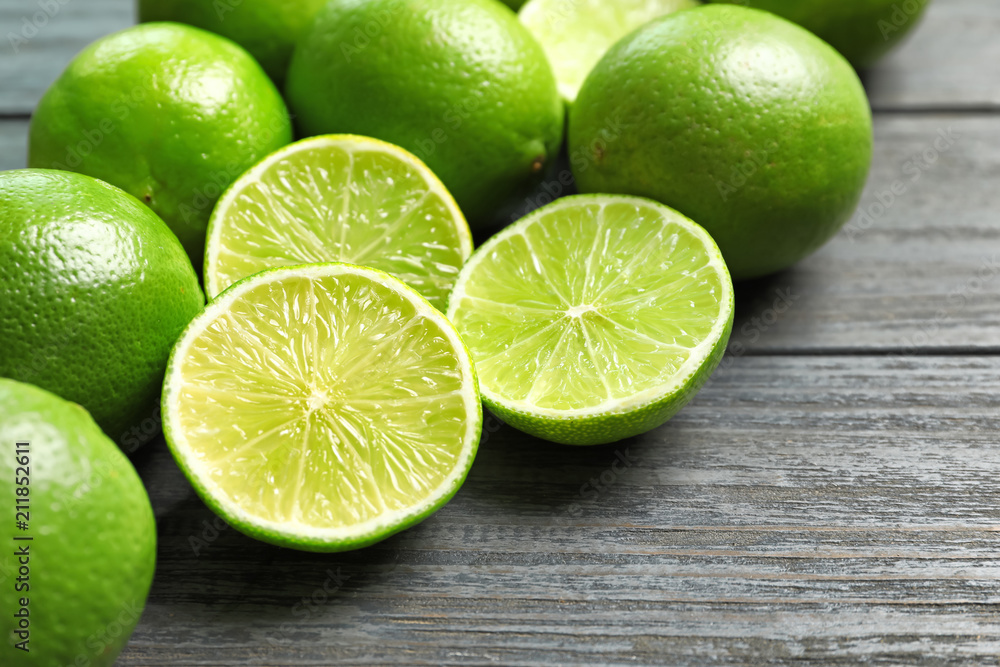 Fresh ripe limes on wooden table. Citrus fruit