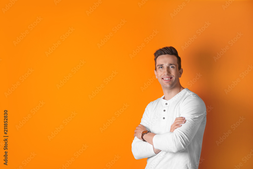 Handsome young man smiling on color background Handsome young man smiling on color background