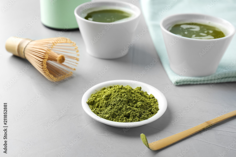 Plate with powdered matcha tea and chashaku on table Plate with powdered matcha tea and chashaku on table