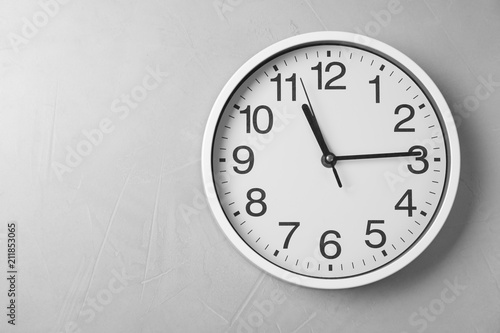 Modern clock on grey background, top view. Time management
