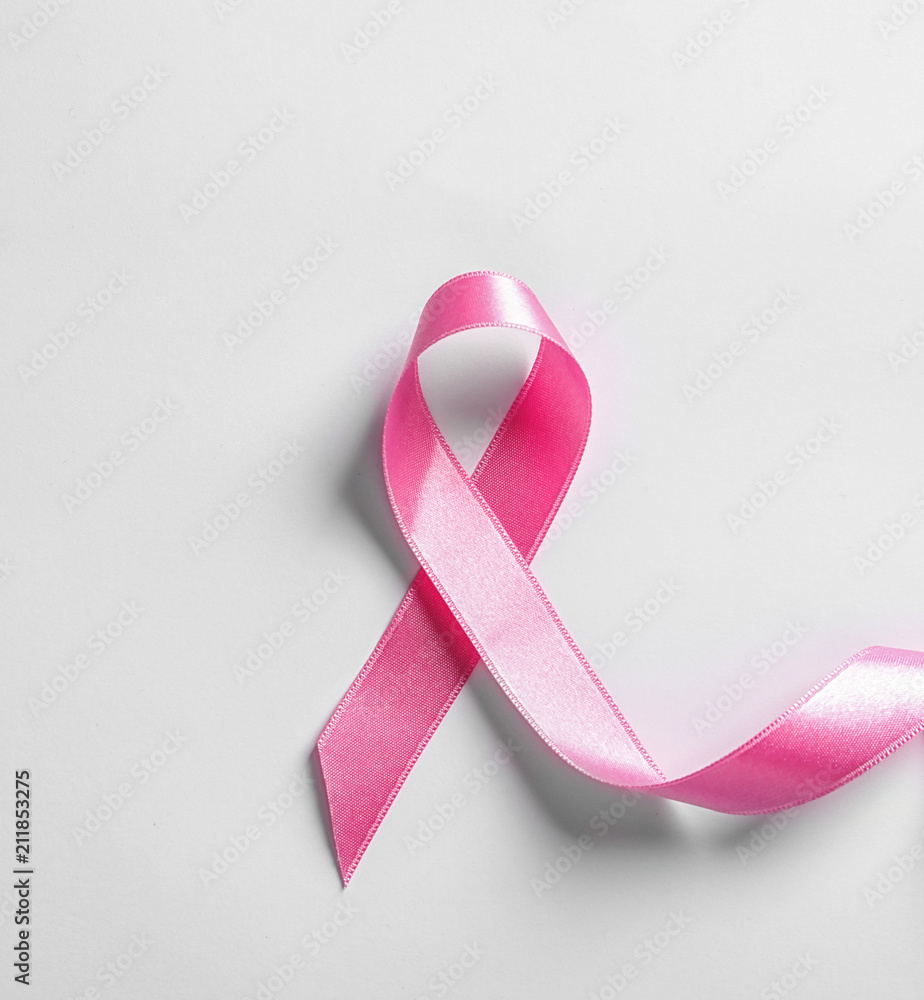 Pink ribbon on white background, top view. Cancer awareness Pink ribbon on white background, top view. Cancer awareness