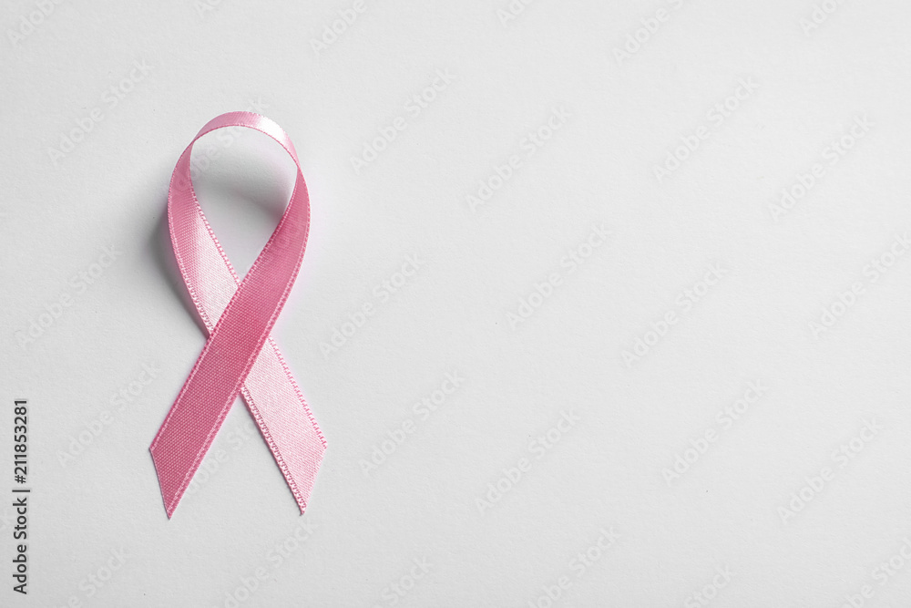 Pink ribbon on white background, top view. Cancer awareness Pink ribbon on white background, top view. Cancer awareness