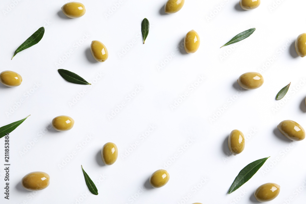 Flat lay composition with fresh olives covered with oil on white background