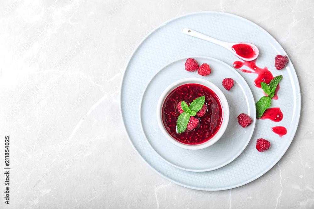 Composition with delicious raspberry jam on plates, top view Composition with delicious raspberry jam on plates, top view
