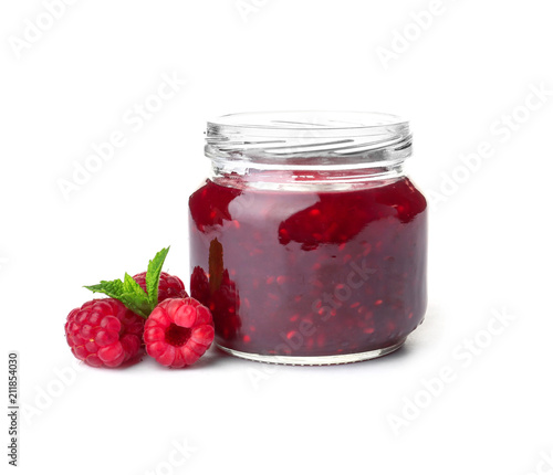 Jar with delicious raspberry jam on white background photo