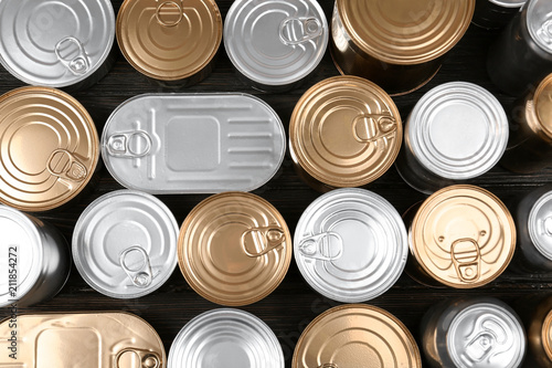 Many tin cans on wooden background, top view. Recycling garbage