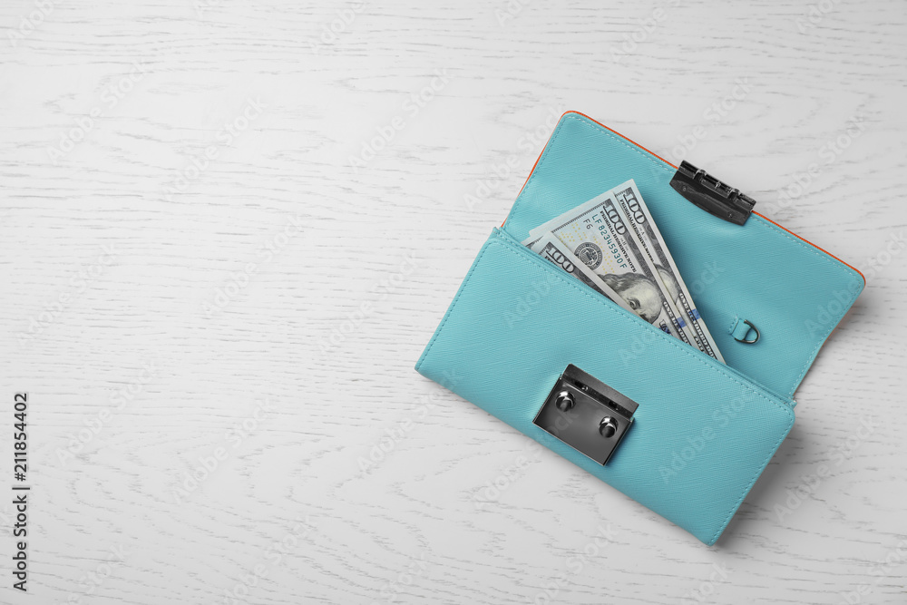 Fototapeta premium Stylish wallet with cash on light background, top view