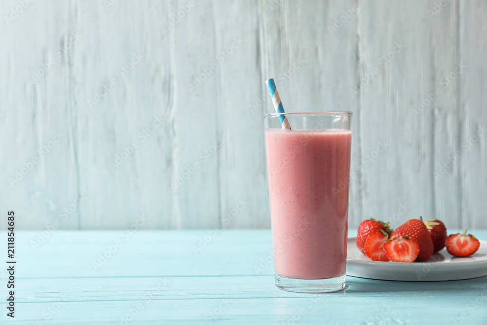 Glass jar with tasty strawberry smoothie on table Glass jar with tasty strawberry smoothie on table