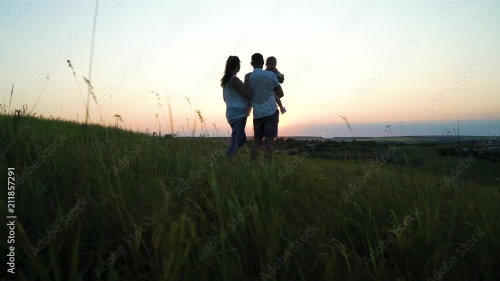 Pregnant couple with toddler daughter have leisure time outdoors at sunset. Happy young parents with child at sunset. Father holding kid. Parenthood, pregnancy, childhood, healthy, activity concept Pregnant couple with toddler daughter have leisure time outdoors at sunset. Happy young parents with child at sunset. Father holding kid. Parenthood, pregnancy, childhood, healthy, activity concept