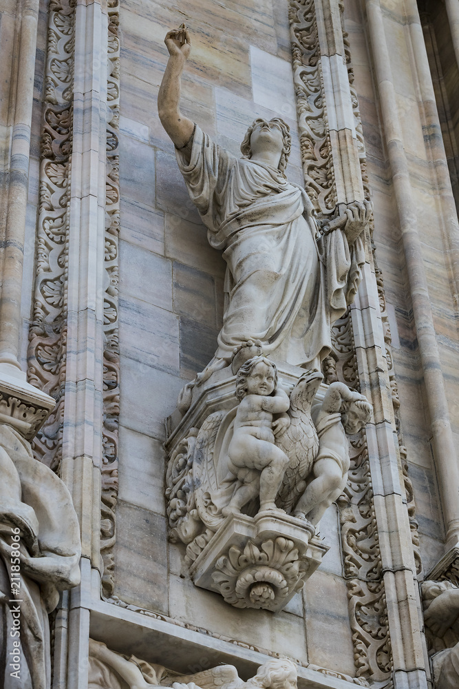 Fototapeta premium Sculptures of saints and martyrs decorating the Cathedral of Milan (Duomo di Milano) are shot close-up. 