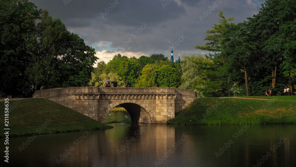 An old Park with a bridge in a thunderstorm. Gatchina. Russia. An old Park with a bridge in a thunderstorm. Gatchina. Russia.