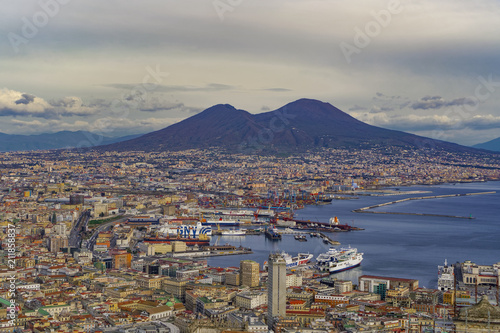 Panoramic city view over Seaport of Napoli with ships and Mount Vesuvius volcano, seen from Sant Elmo castle, Naples, Campania photo