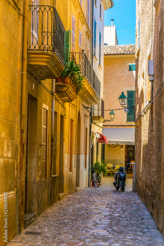 View of a narrow street in the old town of Pollenca, Mallorca, Spain photo