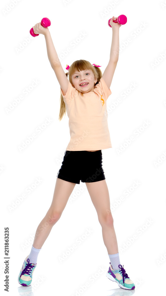 Little girl doing exercises with dumbbells.