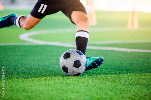 The soccer player shoot ball on artificial turf. © Koonsiri