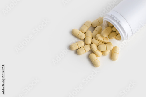Yellow Pills For Health And Plastic Bottle Container