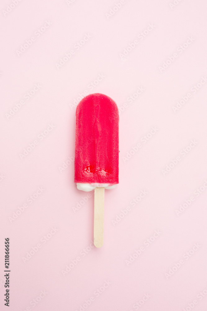 Popsicle with fresh strawberry on pink Popsicle with fresh strawberry on pink