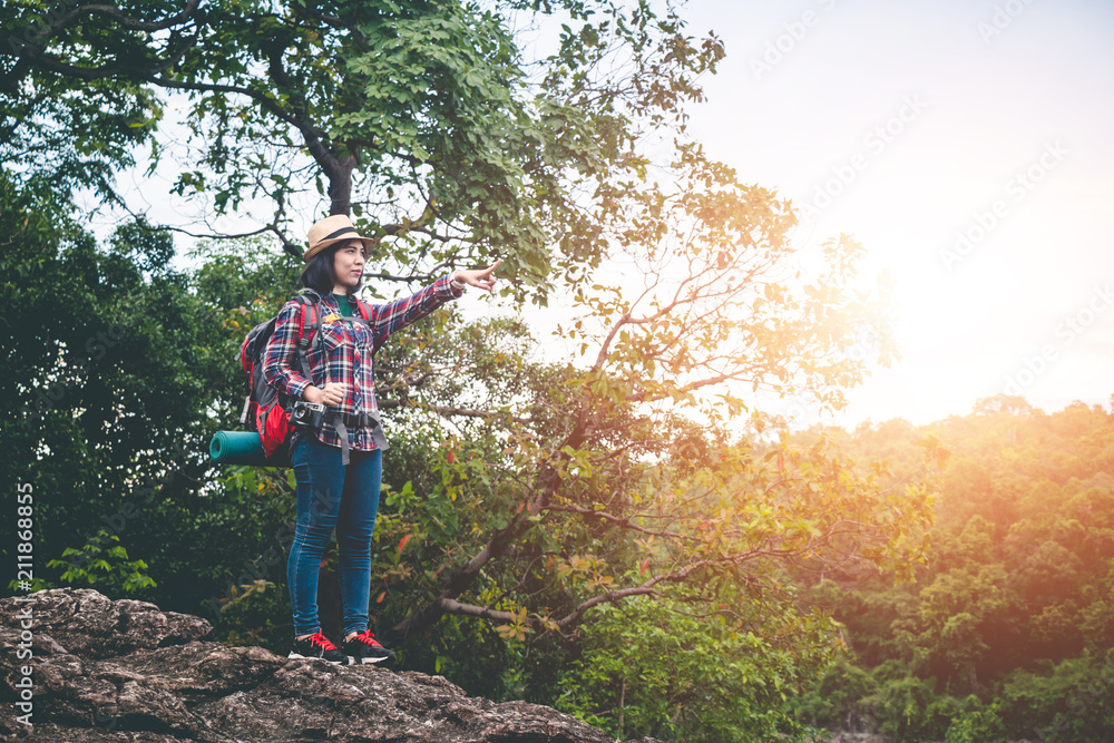 Fototapeta premium Female tourists in beautiful nature in tranquil scene, concept tourists backpack.