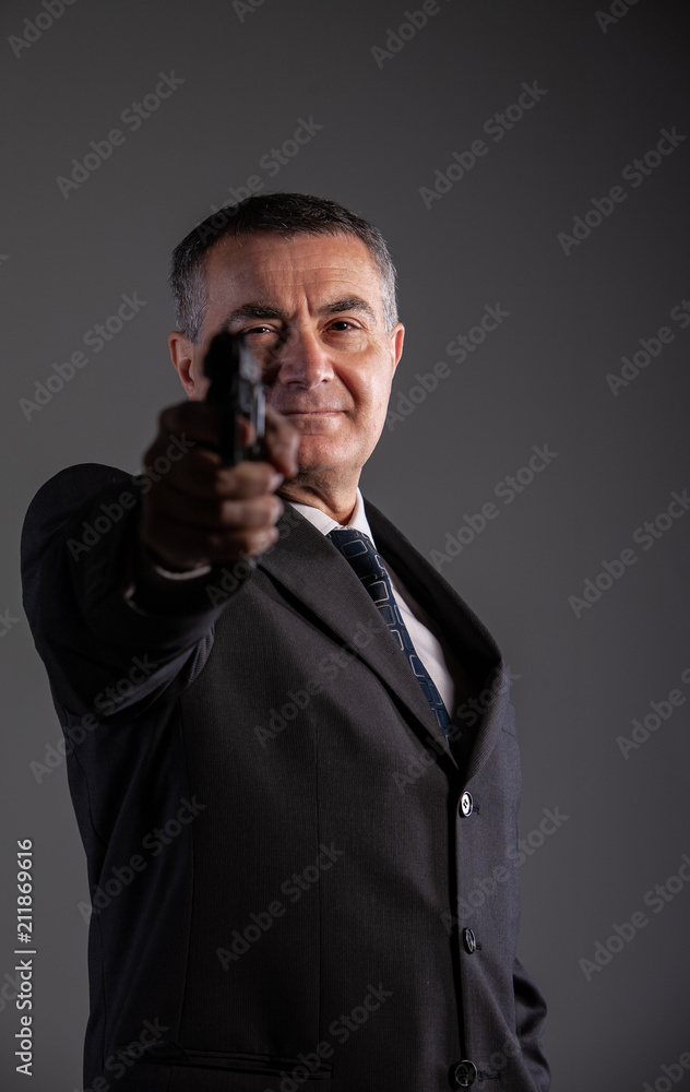 old man is a killer pointing a revolver old man is a killer pointing a revolver