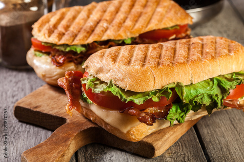 Toasted ciabatta sandwich with smoked bacon, cheese and tomato
