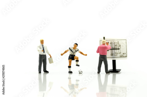Miniature people : Soccer Football Coaches are Planning with the Players in the Tournament.